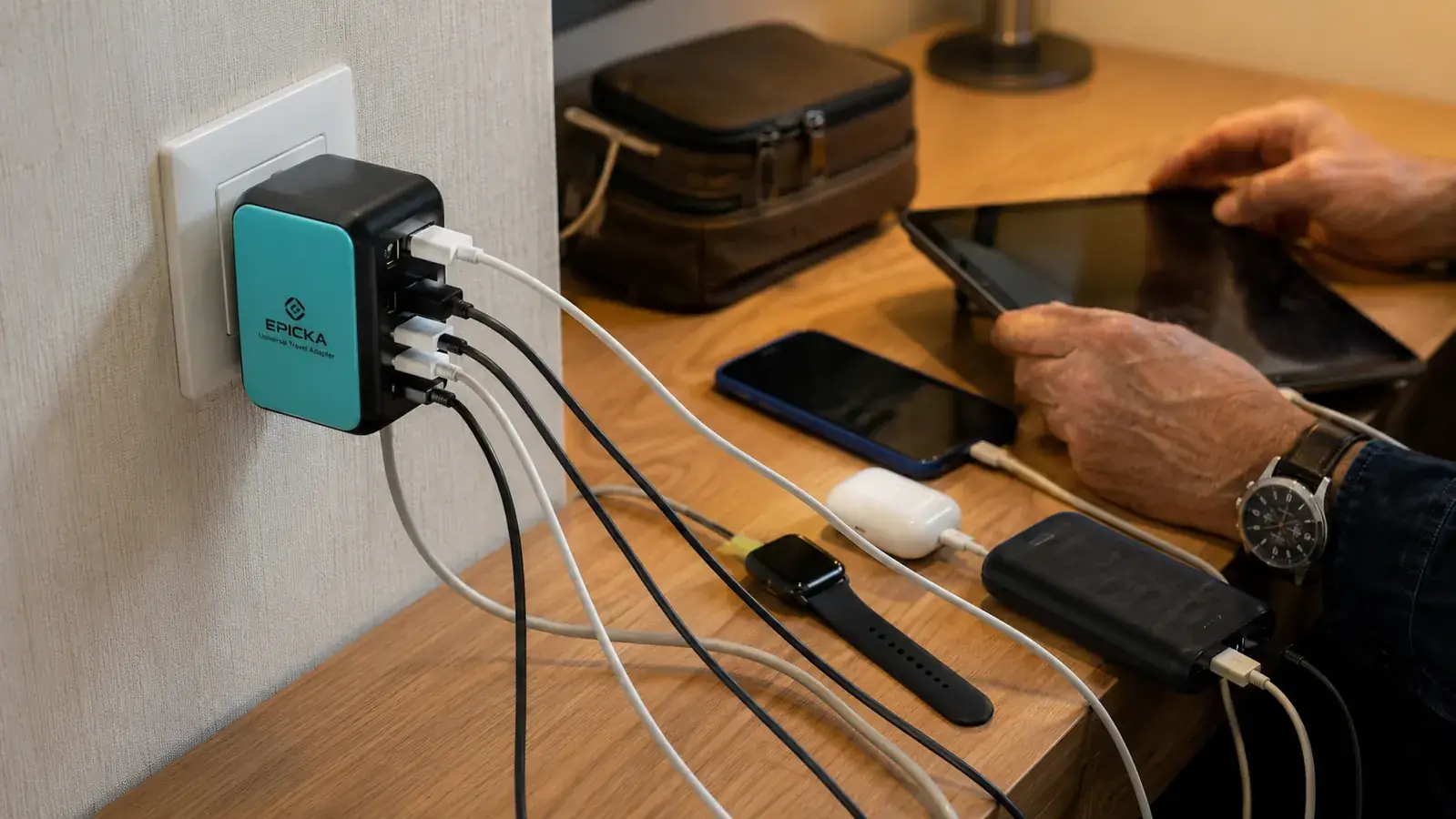 EPICKA travel adapter with four USB cables plugged in simultaneously showing USB-C and USB-A ports in use