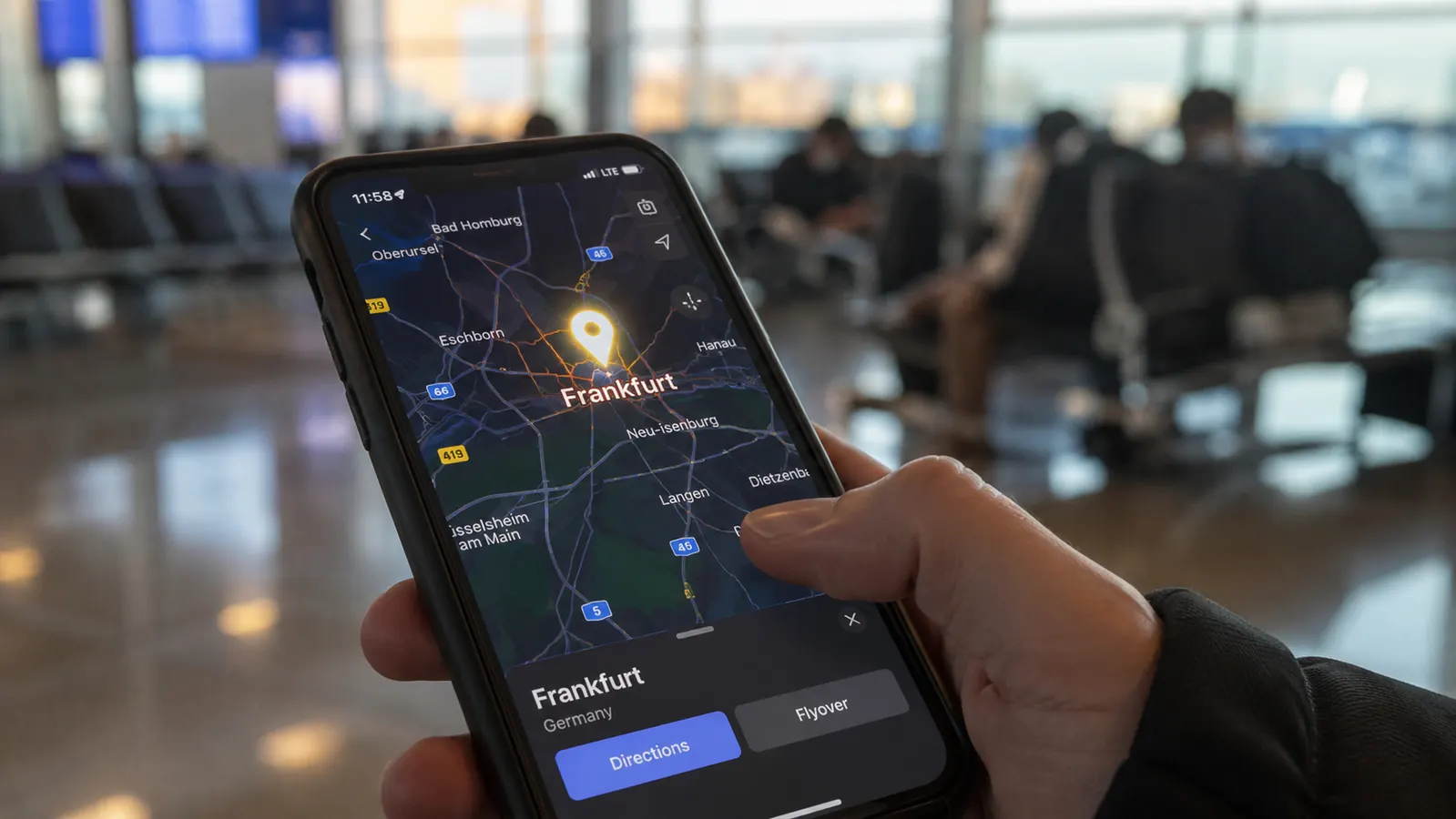 Smartphone screen showing a map with a blue location pin over Frankfurt Germany