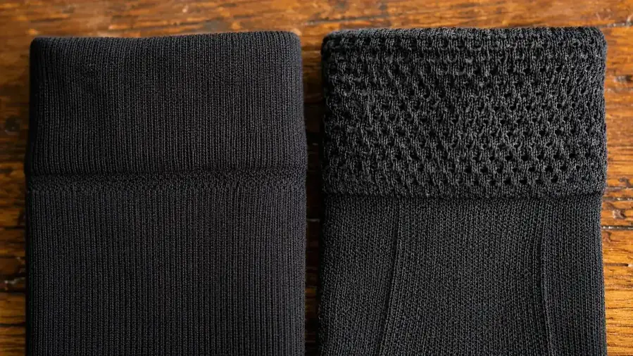 Side-by-side close-up of compression sock fabric weave showing the difference in knit density between two pairs